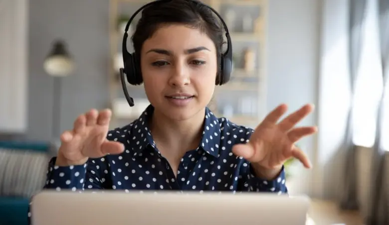 Indian woman teacher wear wireless headset video calling on laptop picture id1198252567
